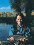 Woman Fly Fishing in Co  Holding Fish