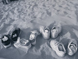 Four Pairs of Shoes on the Sand