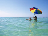 Young Women in Ocean with Umbrella