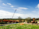 Crane Lifitng Steel Piling Beside River Avon During Construction of the Barford Bypass  England
