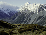 Hikers Look up at Snowy Mountain Top  New Zealand