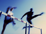 Low Angle View of Athletes Jumping over Hurdles