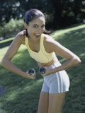 Young Woman with Dumbbells Posing