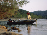 Man Standing in a Boat Fishing