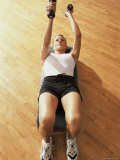Young Woman Exercising in a Step Aerobics Class