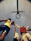 Low Angle View of Three Young Men Playing Basketball