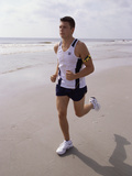 Young Man Jogging on the Beach