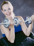 Portrait of a Young Woman Exercising with Dumbbells