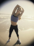 Young Woman Stretching on the Beach