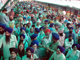 Indian Sikh Pilgrims Wait for Immigration Clearance at Wagah Railway Station Near Lahore