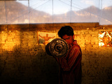 A Young Afghan Man Exercises with a Barbell in Kabul
