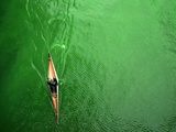 A Lone Kayaker Travels Down the Chicago River after It was Painted Green