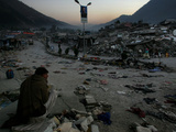A Homeless Pakistani Earthquake Survivor Sits on the Roadside