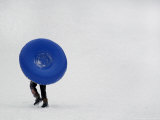 A Young Sledder Totes His Tube Back up the Hill