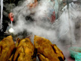 A Young Boy Sells Chicken Broth at a Stall