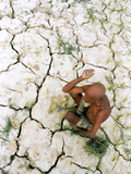 An Indian Farmer Sits in His Dried up Field in Hanumanganj  India