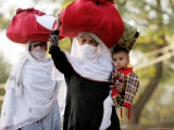 Kashmiri Women Carry on Their Heads Relief Goods