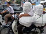 A Motorbike Taxi Maneuvers its Way Through City Traffic