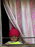 A Nepali Child Looks out from a Window at Pro-Democracy Activists