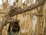 A Sudanese Girl Plays Inside a Thatched Hut at the Refugee Camp of Zamzam