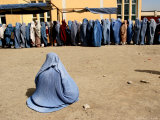 Afghan Widows Waits for Food During a Distribution Program by Care