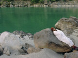 A Hindu Pilgrim Rests Along the Peaceful Bank of the Ganges River Near Rishikesh