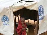 A Sudanese School Girl Stands Infront of Her Class Room