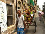 A Rickshaw Puller Carries Supporters of Brazil Soccer Team