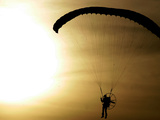 An Engine-Powered Paraglider Soars Through the Air Near Schlesen