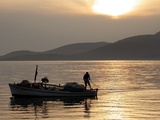 Lone Fisherman Casts His Net at Twilight off the Adriatic Coast