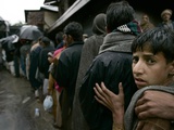 Pakistanis Wait in Line to Receive Food as Aid