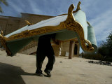 An Iraqi Man Trudges Under the Weight of a Couch He Looted from a Gated Elite Housing Compound