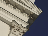 The Corner of a Tall Building with an Ornate Column and Eves