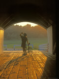Bicyclist at Covered Bridge  Iowa  USA