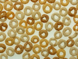 Round Healthy Breakfast Cereal Scattered on a White Surface