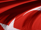 Close-up of the Flag of Turkey with a White Star and Moon on Red Fabric