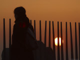 Person Walking along Posts