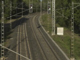 Two Sets of Railroad Tracks with Signal Lights on Poles