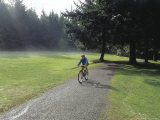 Person Cycling on a Path in a Park
