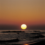 Yellow Sun in Sunset Over Ocean Waves