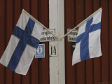 A Red Clapboard Building with Two Flags of Finland