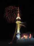 Illuminated Tower and Buildings with Colorful Fireworks