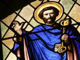 Illuminated Stained Glass Window with a Holy Figure Holding a Key