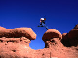 A Man Jumps onto a Hoo-Doo Formation in Goblin Valley  Goblin Valley State Park  Utah  USA