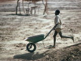 Boy Running with Wheelbarrow  Burkina Faso