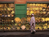 Man Walking Past Brass Platters and Trays  Luxor  Egypt