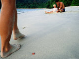 Man and Child Sitting on Beach  with Legs of Another Man in Foreground  Phuket  Thailand