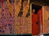 Buddhist Monk Standing in Doorway of Wat Xieng Thong  Luang Prabang  Laos