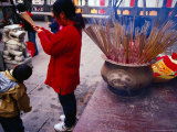 Woman Burning Incense at Wong Tai Sin Temple  Kowloon  Hong Kong  China