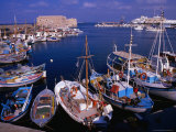 Fishing Boats in Harbour with Venetian Fortress Herakleion in Distance  Greece